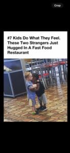 Two young children hugging inside a fast food restaurant.