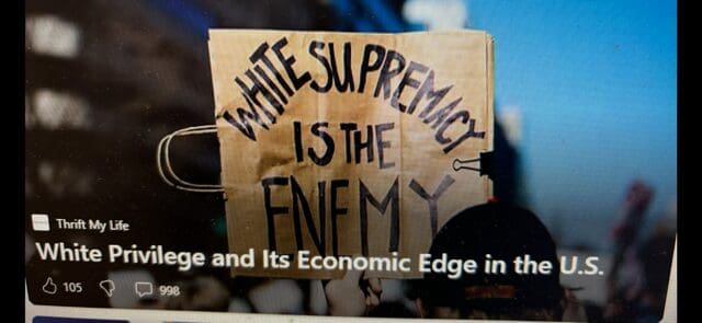 Protest sign stating 'White Supremacy Is The Enemy'.