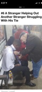 An older man helping a young man tie his tie on a train.