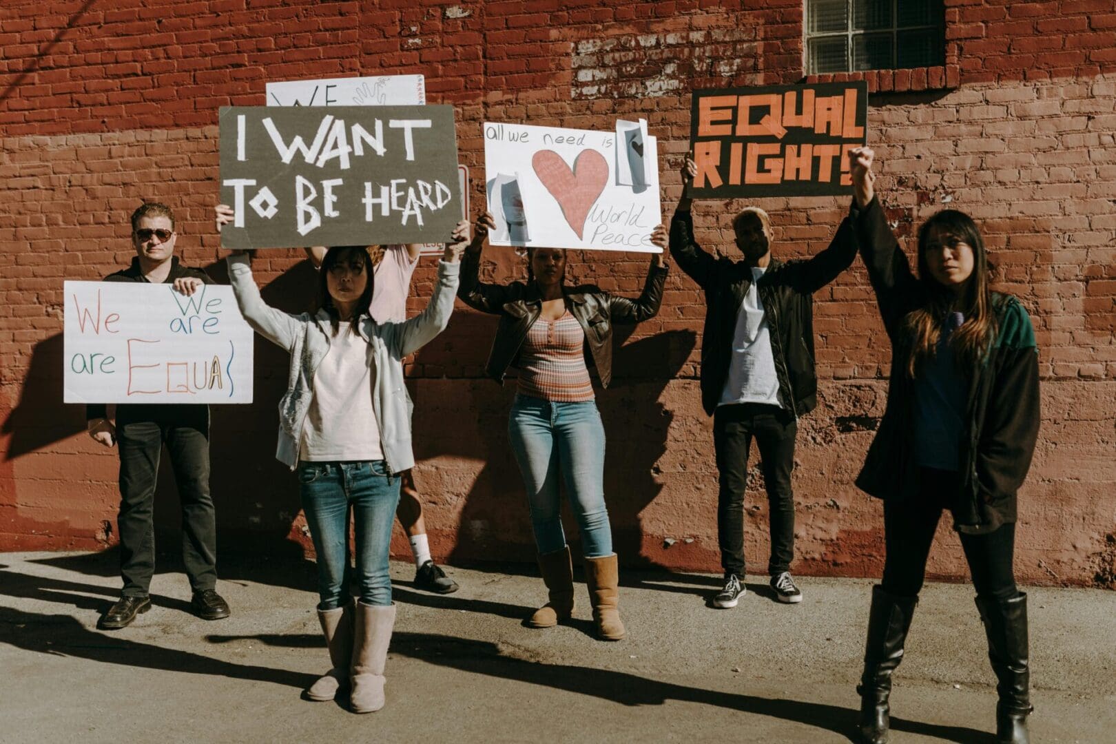 A group of diverse protesters holding signs advocating for equal rights and respect.