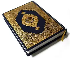 A beautifully decorated Quran with intricate gold detailing on the cover.
